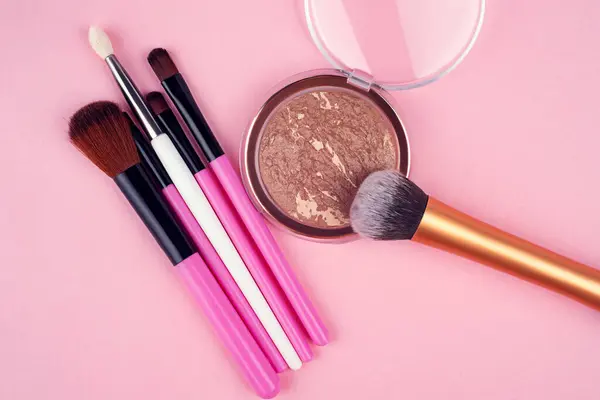 Decorative cosmetics, set of cosmetics on a pink background