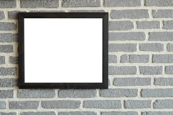 Black natural wooden frame on bricks wall. Mock up blank poster picture frame on brick wall.