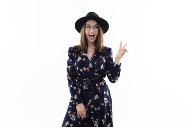 Stüdyoda kameraya poz veren uzun çiçekli bir elbisesi olan esmer bir kadın. Duygusal Portre