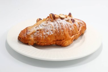 Beyaz tabakta fındıklı taze pişmiş kruvasan.