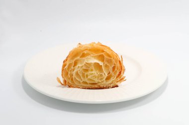 Taze pişmiş geleneksel kruvasan iki parçaya bölünmüş.