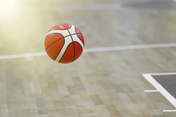 Basketball ball on the parquet of basketball court