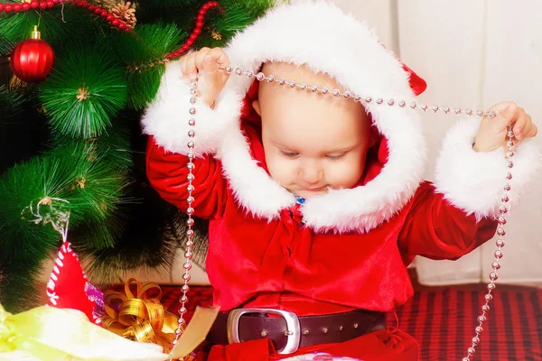 Kisfiú a karácsonyfa, ajándékok a kezében. Karácsonyi. Ajándékok. Az ünnepi hangulat. Gyermekkori — Stock Fotó