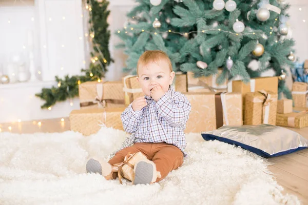 在圣诞树旁和用花环和礼物装饰的壁炉旁 可爱的小男孩 圣诞气氛 — 图库照片
