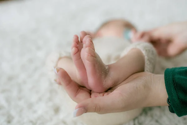 Mom Hands Hold Little Cute Legs Baby Who Lies Wicker — Stock Photo, Image