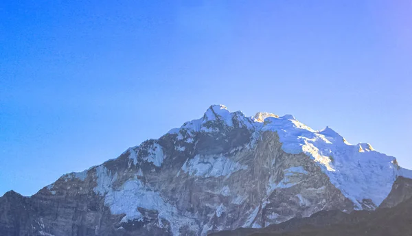 Montagna innevata con cielo blu, nuvola e nebbia — Foto Stock