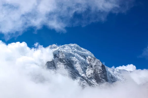 In cima alla collina, coperta di neve e nuvole bianche — Foto Stock