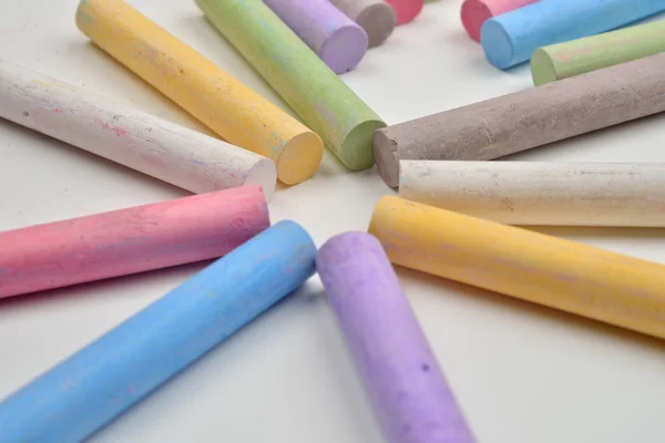 Close up of a lot of colored chalk pieces on on a white backgrou — Stock Photo, Image