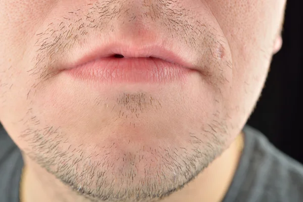 Labios, barba corta de un joven. Concepto foto de sexualit masculino —  Fotos de Stock