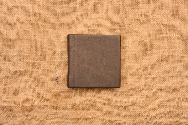 Picture of dark brown leather photo album cover on jute backgrou — Stock Photo, Image