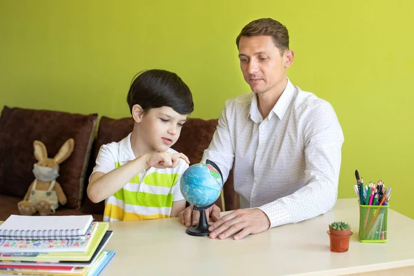 Boy with father doing homework during the coronavirus quarantine.