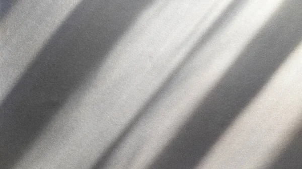 Diagonal shadows on blue dark gray paper. Abstract backgorund. Stock photograohy.