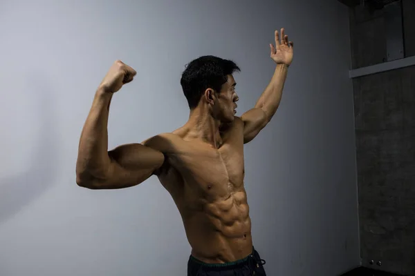 Fitness Model Displaying Upper Body Physique