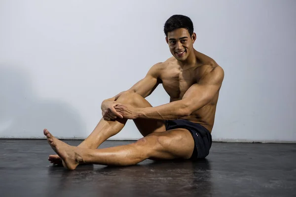 Fitness modell tar en paus som sitter på golvet — Stockfoto