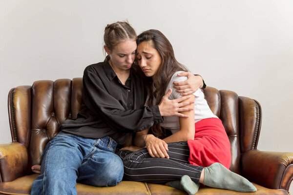 Sad Young Woman Being Consoled by Girlfriend