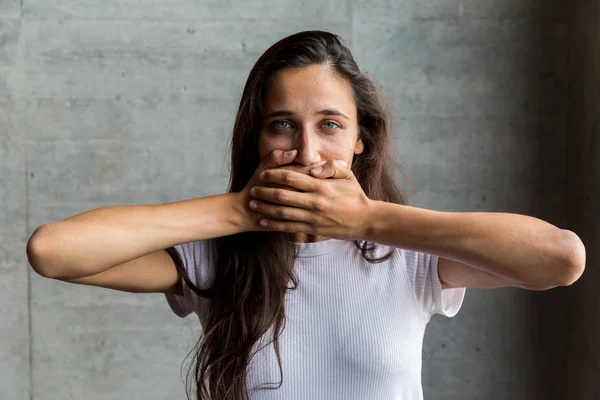 Portrait of Young Woman with Light Colored Eyes Using Hands to Cover Mouth — Stock Photo, Image