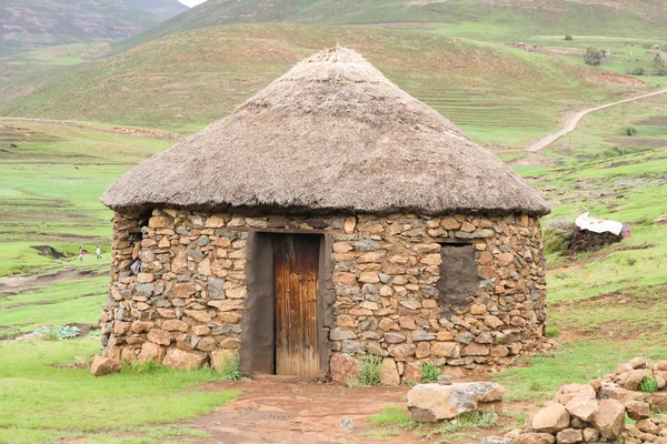 Traditional stone bungalow with straw roof without people Stock Picture