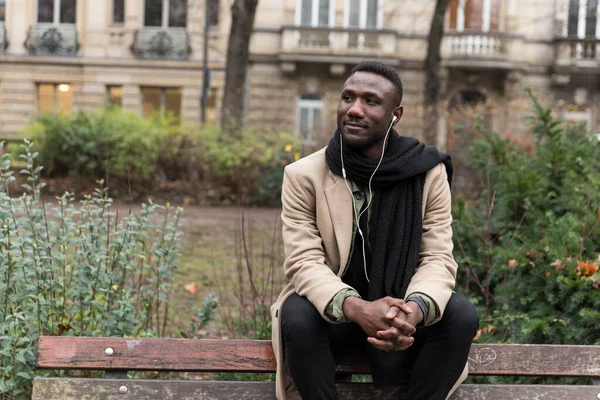 Young Black Man Sitting Park Bench Autumn Listing Audiobook Thinking — Stock Photo, Image