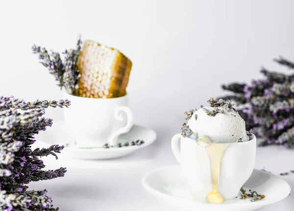 lavender honey ice cream in a coffee cup, lavender flowers, honey honeycombs, white background, high key