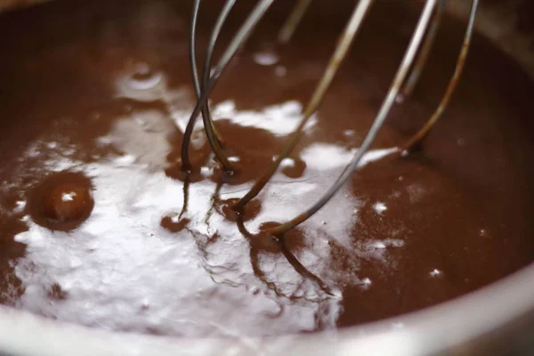 Whisking eggs and melted chocolate. Making Chocolate, Pear and Pecan Pie Series.