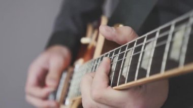 Gitardaki parmaklar rock, jazz ve blues sololarını çalıyor. Elektro gitar çalarken ellerinizi kapatın. Rock konseri için gitar provası