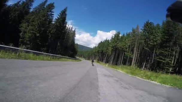 Man cycling and hard training on road bike among pine forest in mountains. Professional cyclists pedaling on bicycles. POV, Original point of view. Cycling and triathlon concept — ストック動画