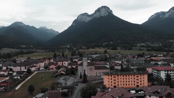 Dolina górska z domkami i domkami letniskowymi, Alpy, Francja. Drone widok na Doussard gminy z górami na tle. Niesamowite Alpy z lotu ptaka — Wideo stockowe