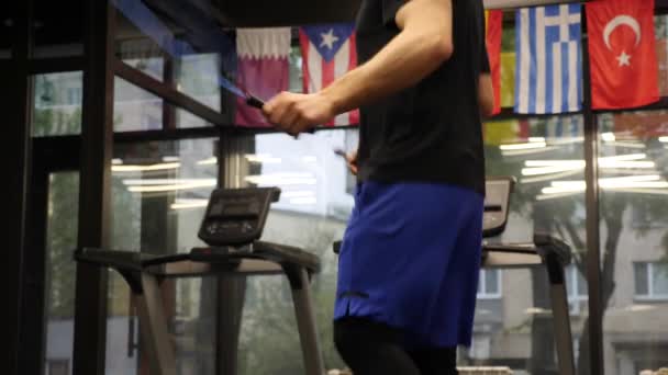 Pessoa pulando corda no ginásio de fitness. Atleta profissional fazendo treinamento cardio intenso. Homem fazendo exercícios matinais indoor — Vídeo de Stock