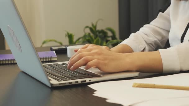 Женские пальцы печатают на клавиатуре ноутбука. Женщины на ноутбуке в офисе, с близкого расстояния. Бизнесмен печатает письмо на компьютере. Девушка использует сенсорную панель при написании текста на ноутбуке. Концепция бизнеса — стоковое видео