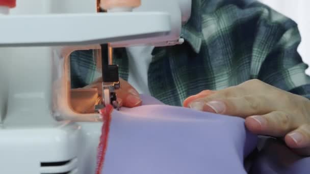 Επαγγελματική γυναίκα μοδίστρα εργάζεται στη ραπτομηχανή. Κοντινό πλάνο των γυναικείων χεριών ράψτε ύφασμα στο στούντιο του ράφτη. Δημιουργία και προσαρμογή ρούχων. Γυναίκα που εργάζεται σε χειροποίητο φόρεμα — Αρχείο Βίντεο
