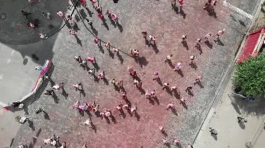 Kyiv/Ukraine - June 2, 2019 - Top view of people running on street of city center smeared colorful holi paints at Color Run Kyiv festival. Women and men jogging at run competition