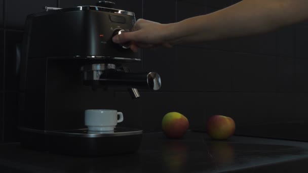 El primer plano de la mano femenina enciende la máquina de café. proceso de preparación del café. Primer plano de la máquina de café haciendo café expreso — Vídeo de stock