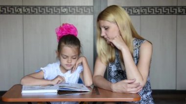 Kız ve annesi dalıp üzerinden okuma ve eğlenceli bakmak içine belgili tanımlık çerçevelemek ve sonra birbirimize