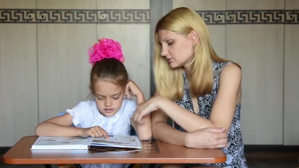 A menina estava assustada eles leram no texto do livro, fazendo com sua mãe — Vídeo de Stock