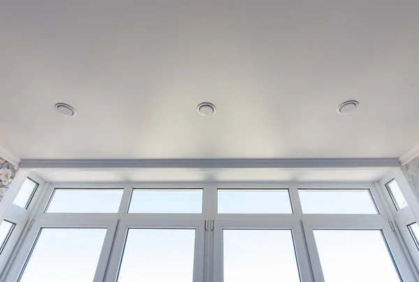 View of the stretch edafter ceiling and part of the glazed-to-ceiling windows — Stock Photo, Image