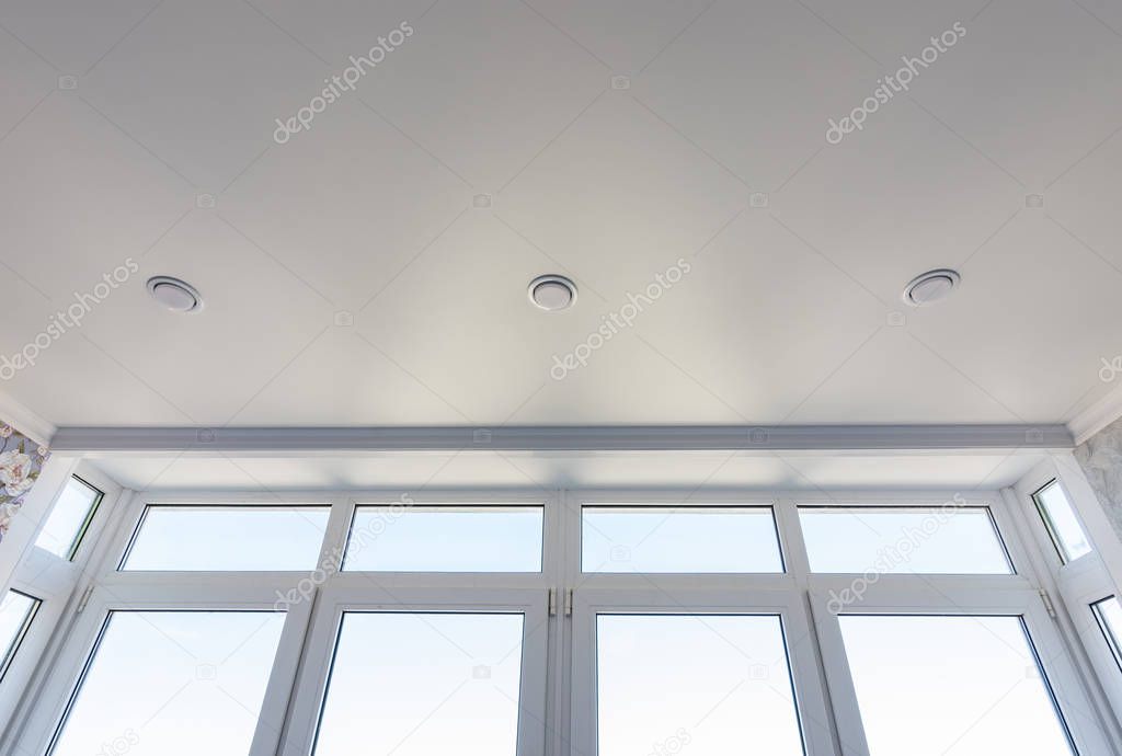 View of the stretch edafter ceiling and part of the glazed-to-ceiling windows