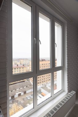 Stained glass high and wide plastic windows in the apartment