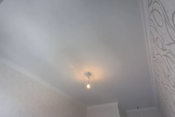 Lined plastered ceilings in a rectangular room after renovation