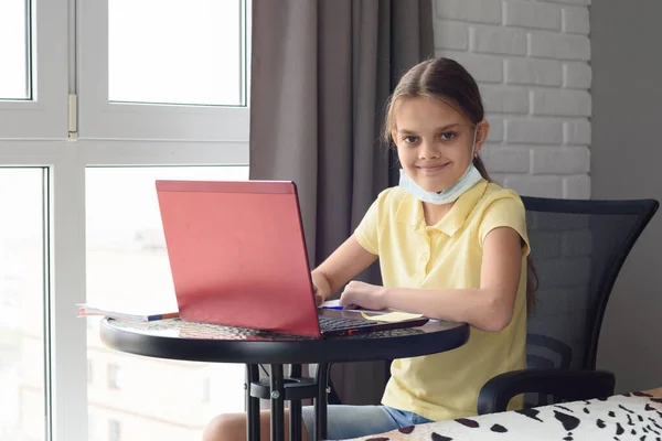 オンラインで宿題をするテーブルで家にいる女の子 — ストック写真