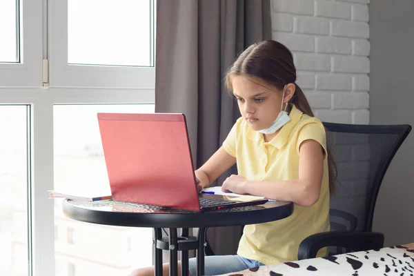 Pensive Child Sitting Table Taking Medical Mask Doing Homework — Stock Photo, Image