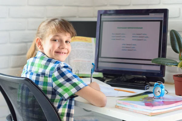 Satisfied Child Sits Computer Table Looks Frame — Stock Photo, Image