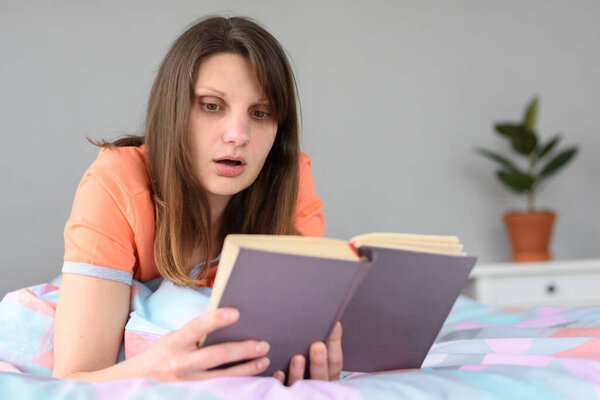 The girl is passionate about reading a book and worries about heroes