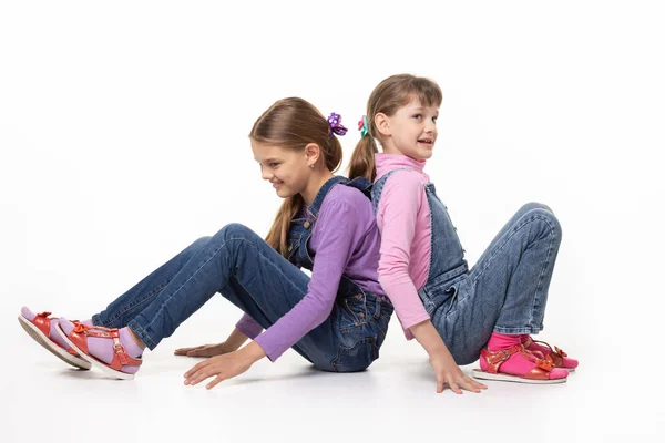 Children Sitting Floor Pushing Backs — Stock Photo, Image