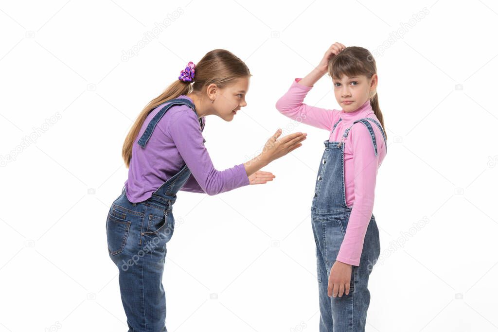 The girl is trying to explain something to her sister, she scratches her head in perplexity