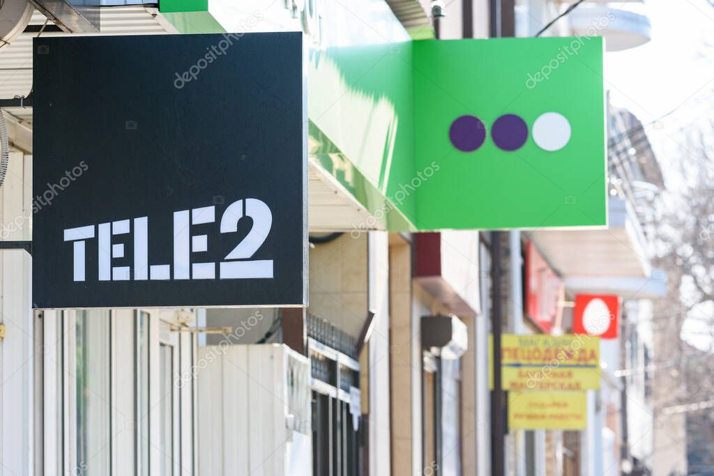 Anapa, Russia - March 20, 2020: A sign of the Russian telecommunications company TELE2, in the background a sign of Megafon, a far sign MTS