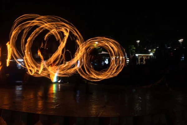 Fire Show Flaming Trails on stage slow shutter exciting event concept space for text — Stock fotografie