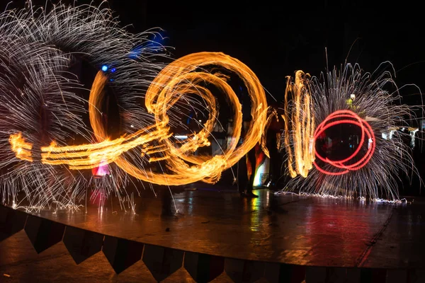 Fire Show Flaming Trails on stage slow shutter exciting event concept space for text — Stock fotografie