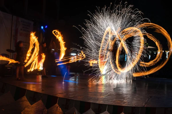 Fire Show Flaming Trails on stage slow shutter exciting event concept space for text — Stock fotografie