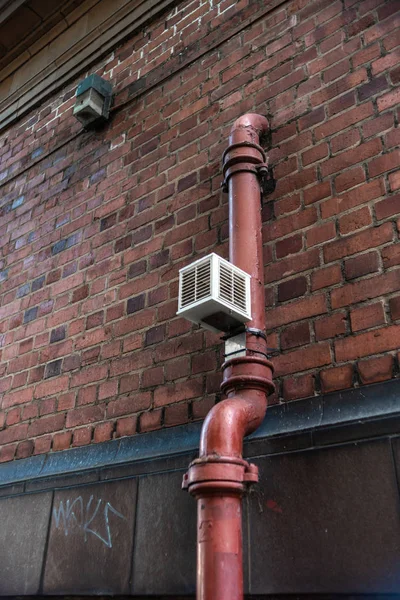 Old pipe brick wall valve vent painted rectangle Urban build texture modern uk city water gas — 스톡 사진