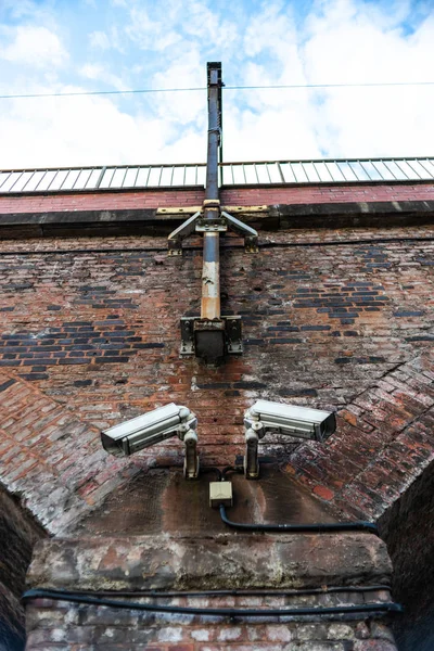 Cctv kamera miejska czerwona cegła ściana wiadukt tory kolejowe manchester oglądanie oczy szpieg problem bezpieczeństwa danych — Zdjęcie stockowe